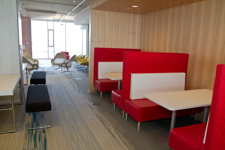 2 sets of red and white booths in an office.