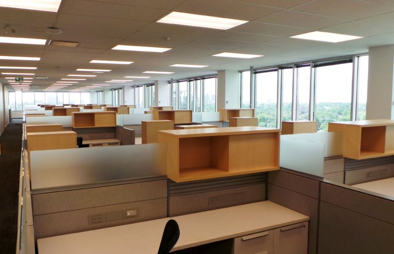 A large open office space with several rows of cubicles
