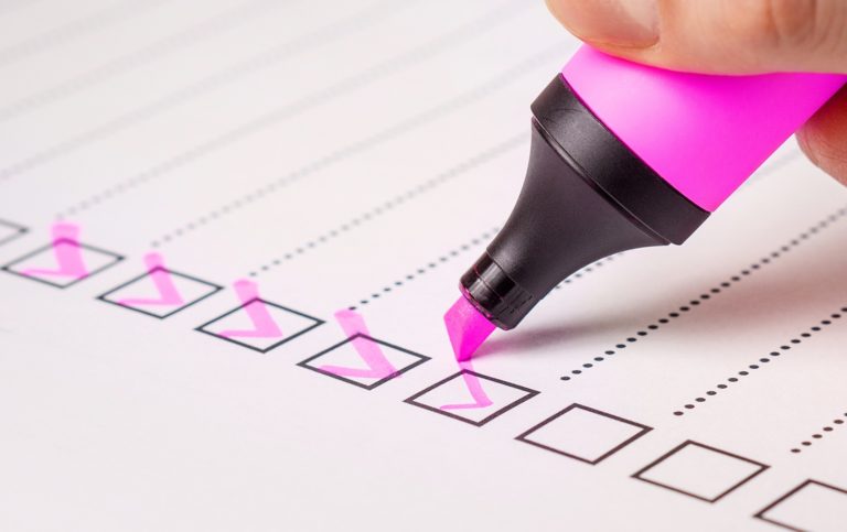 A checklist being marked off with a pink highlighter