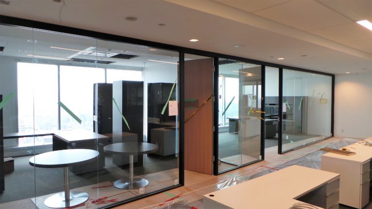 A hallway of offices with newly installed glass walls