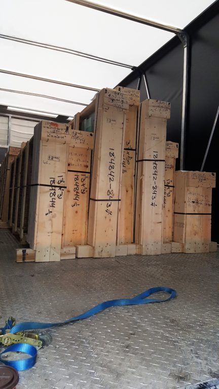 A number of wooden shipping crates in a warehouse